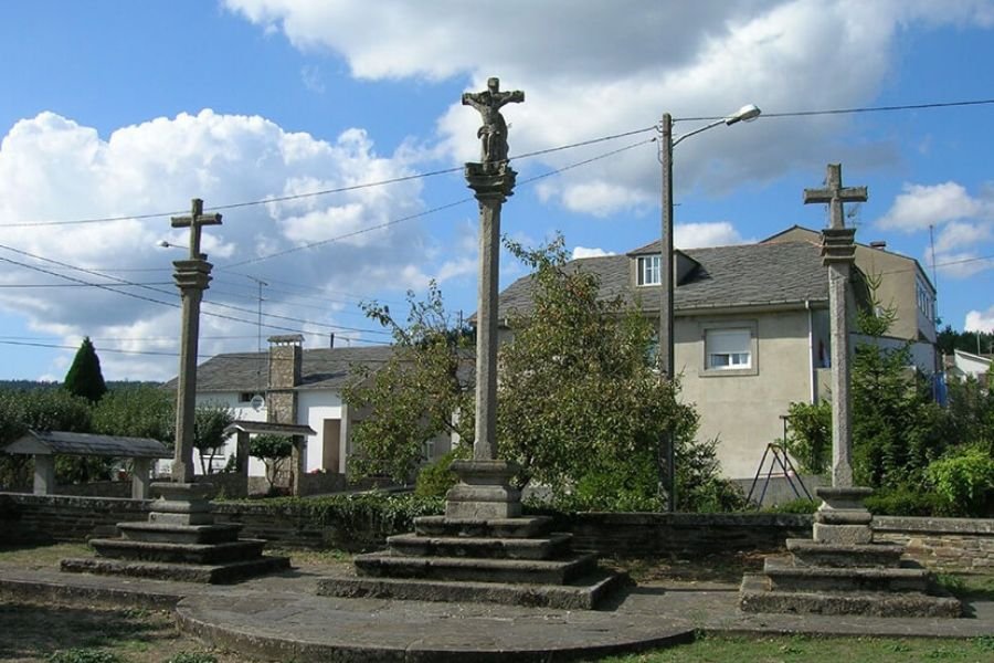 Three stone wayside crosses in a small square in Baamonde
