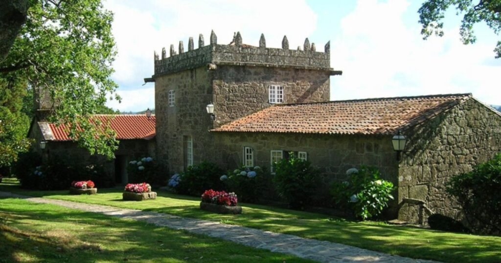Galician pazo with a stone tower and flowering garden, in the style of the manor-house stays on the Camino from Sarria to Santiago